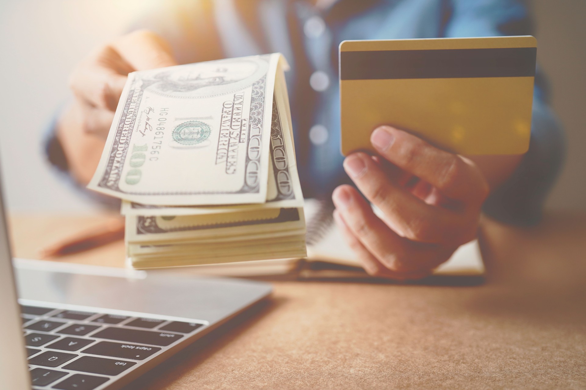 Hands holding credit card with using laptop.